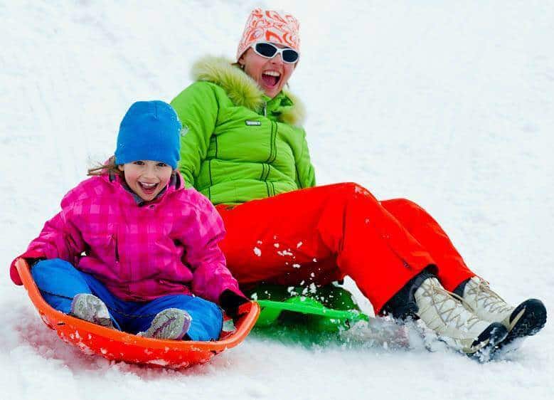 mom and daughter sledding