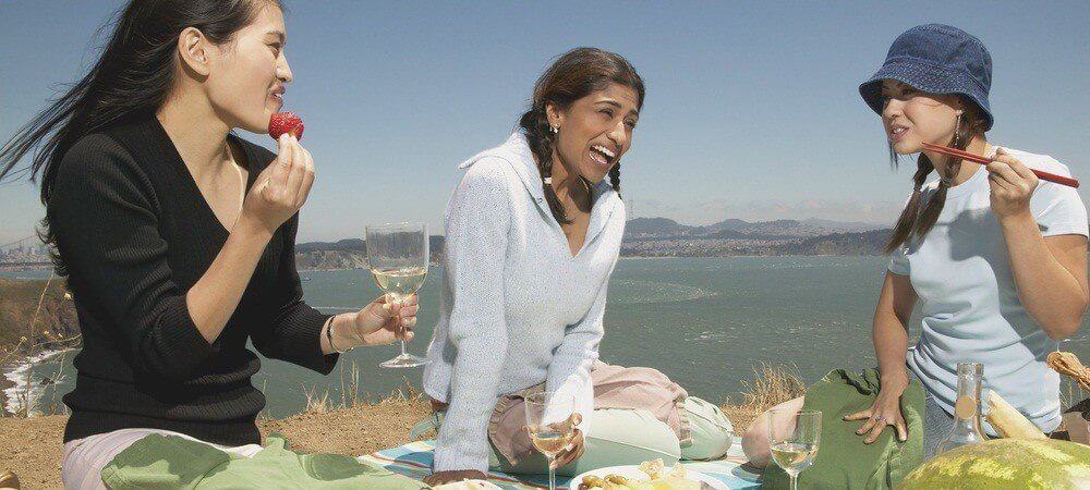 Three woman enjoy the Authumn's grape and wine in the nature.