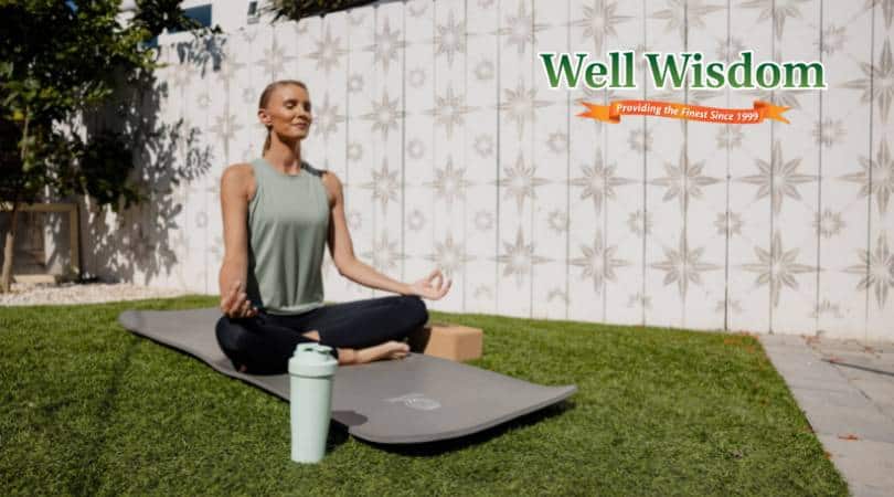 Woman practicing yoga on mat.